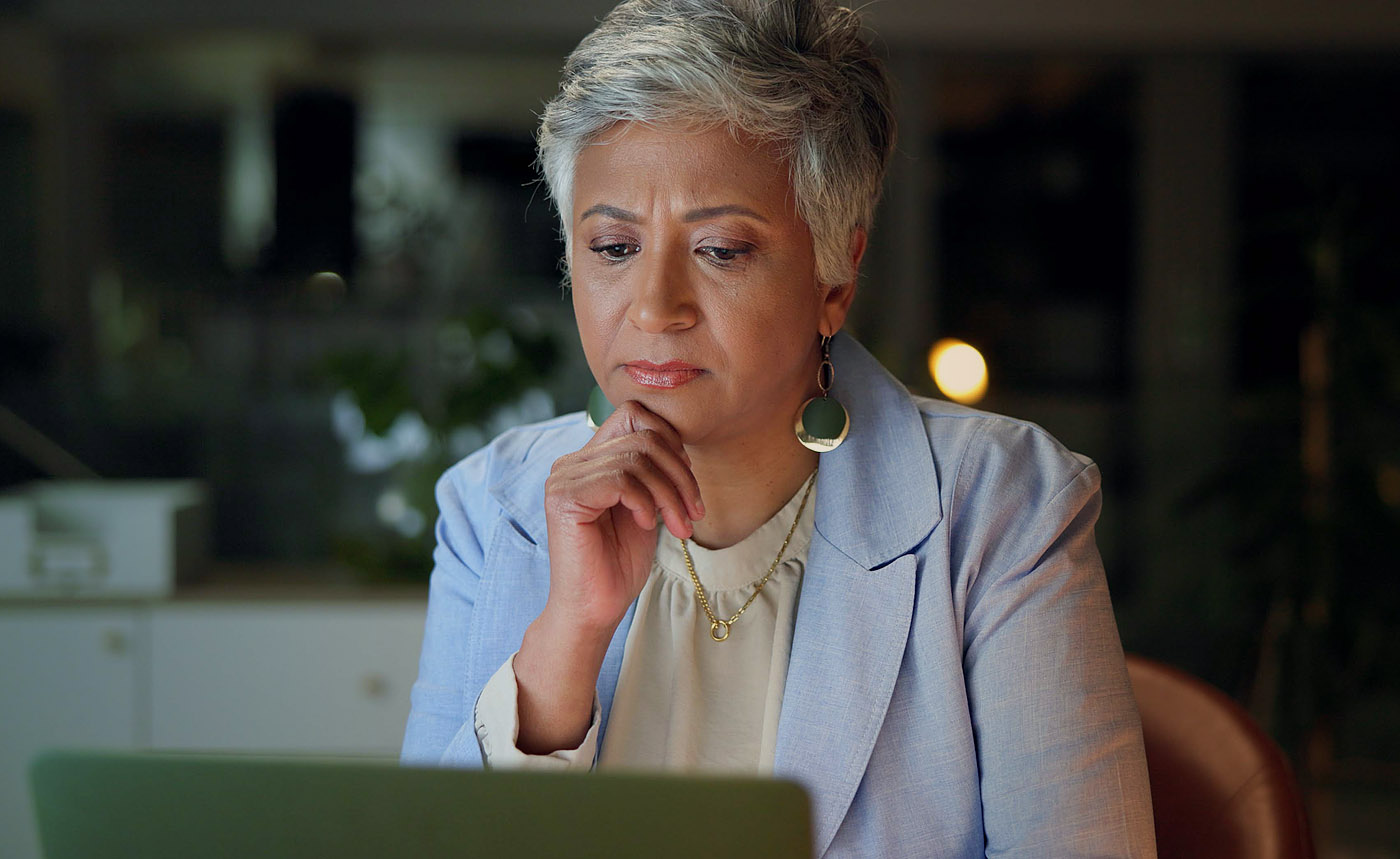 Woman researching non-profit on laptop